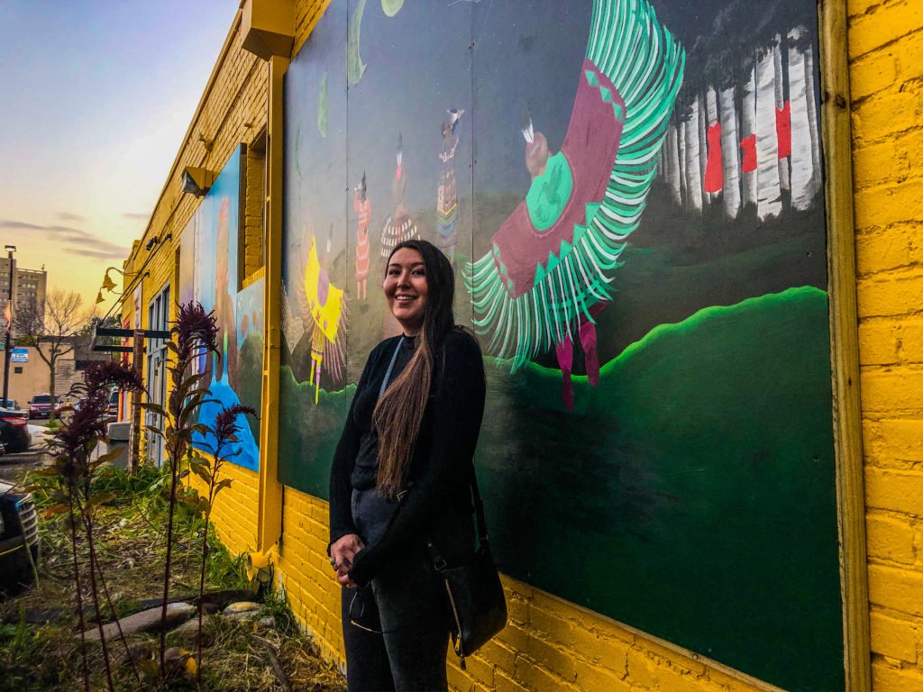 Alex standing in front of Little Earth of United Tribes housing complex